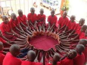 Uganda Orphans gather in a circle