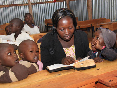 Caregiver reading to kids