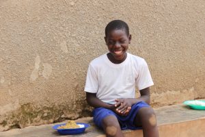 Michael can't hide his smile during lunch time in Uganda.
