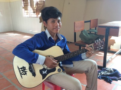 Cambodian boy playing a guitar