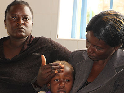 A sick child visiting the medical clinic in Kenya.
