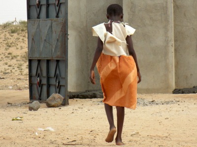 Damaris, an orphan at the Lodwar Kinship in Kenya, needs new clothes.