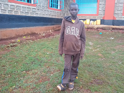 Young boy standing on grass