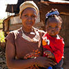 Woman holding a little girl and both looking at the camera