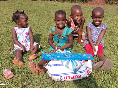 Smiling children in Uganda receiving supplies