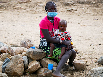 A mother waits with her child for treatment