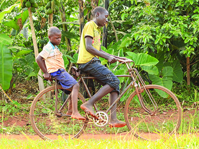 Children in Uganda riding a bike
