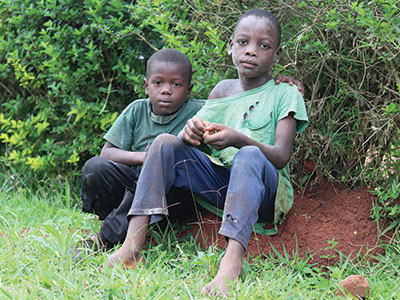 Children in Uganda sitting in the grass