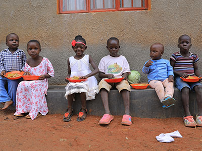 Children eating a Christmas meal at the Buloba Kinship Project