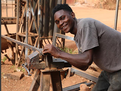 A young man welding in Uganda