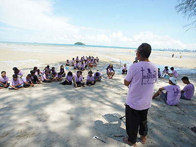 Young adults listening to a speaker during a youth conference in Cambodia