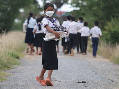 A young girl holding her new school supplies