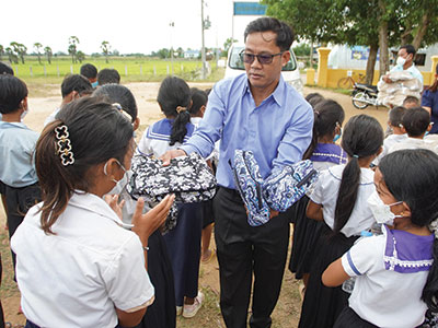 Pastor Jack handing out school supplies