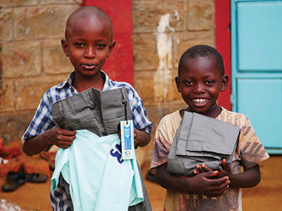 Children holding their Christmas clothes