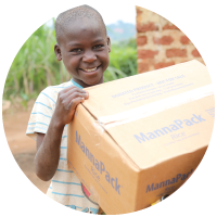 A smiling child receiving a box of food