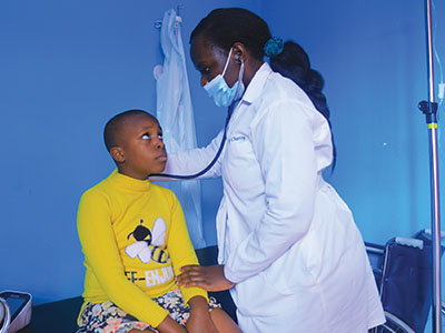 A doctor listening to the breathing of a child