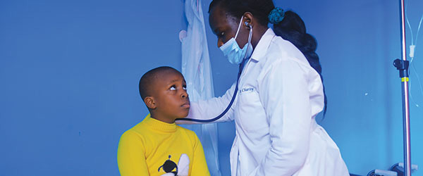 A doctor listening to the breathing of a child