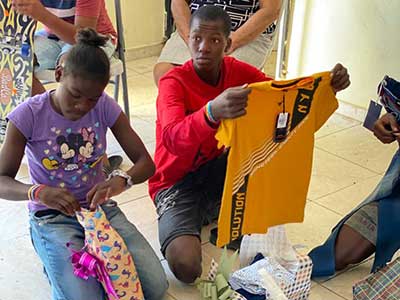 A young man opening his Christmas gift of clothes