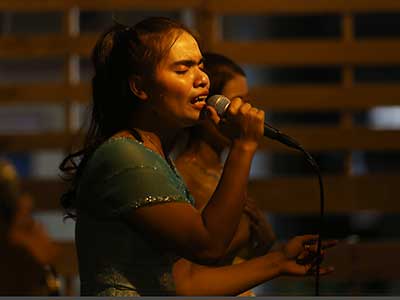 A woman sings worship songs