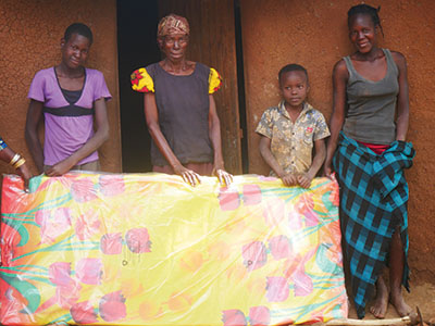 Community members receive their new, jigger-free mattress.