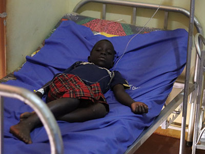 A young child sick in their hospital bed