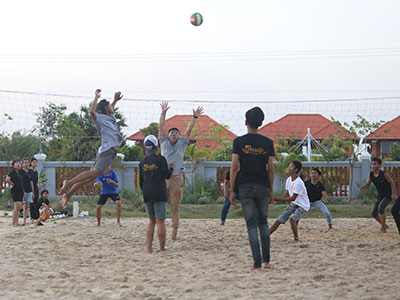 A group of youths playing volleyball