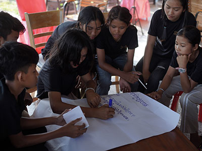 Young adults working on a project during the trip