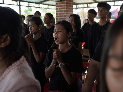 A youth singing in prayer