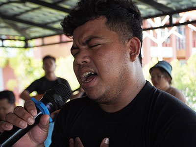 A young man singing in a microphone
