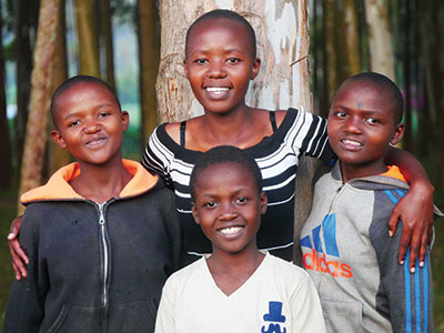 Lydia smiling with her siblings