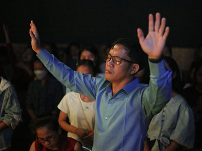 Pastor Jack raises his hands in prayer