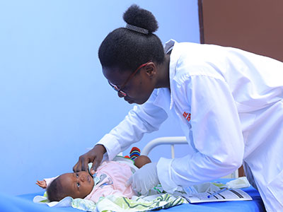 A nurse checks the health of a baby