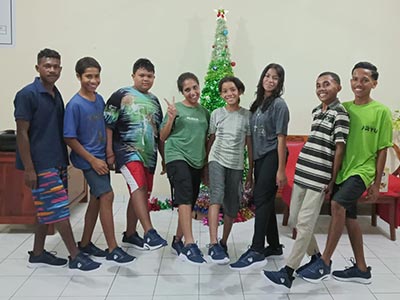 Children in Indonesia showing off their new shoes for Christmas