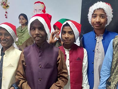 Kinship Kids in Pakistan wearing Santa hats during Christmas festivities