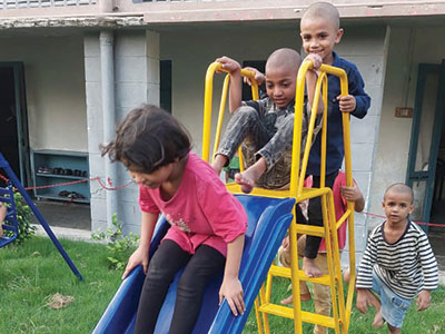 Children at the Lahore Kinship Project playing on their new playground