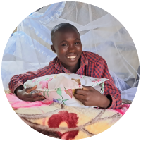 A smiling child in their new bed