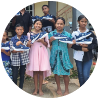 Smiling children holding new shoes