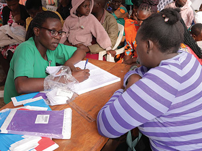 A nurse speaks with her patient