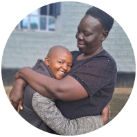 A woman hugging a smiling young girl