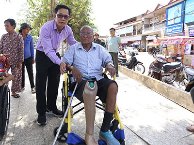 A gentleman sits in his new wheelchair from the outreach event.