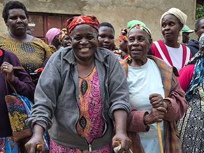 A group of smiling widows during a food distribution event