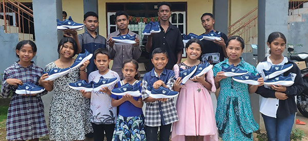 A group of children holding new shoes