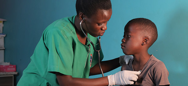 A nurse listening to her patient's heart