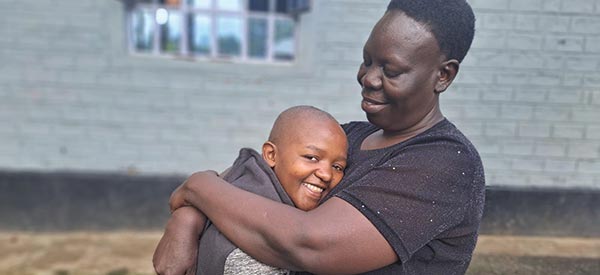 A child hugging her caregiver