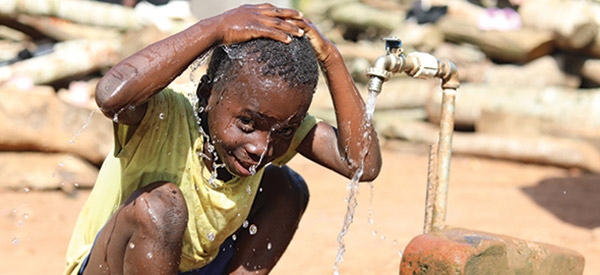 A child washing their head with clean water