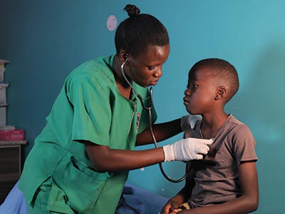 A nurse listening to her patient's heart