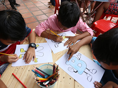 Children color during the Back to School Sunday School event in Cambodia.