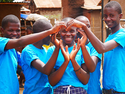 Children making the shape of a heart with their hands