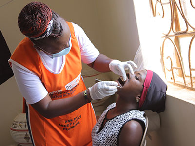 A woman gets her teeth checked during a medical outreach event in Uganda
