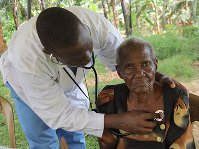 A women receives medical care during a medical outreach event in Uganda